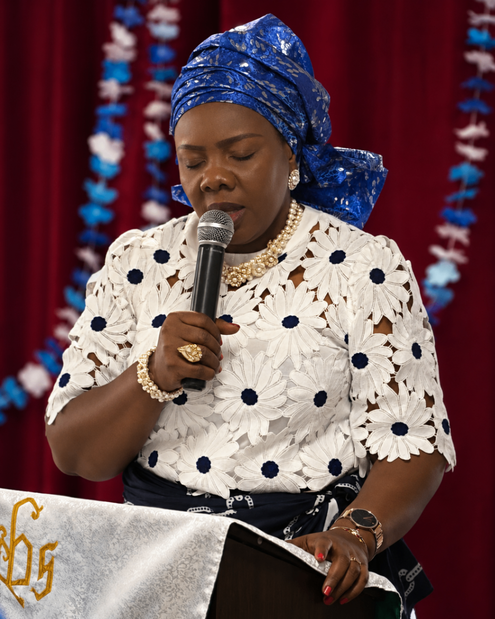 Women's ministry speaker offering prayer at the lectern during Mother's Sunday 2026