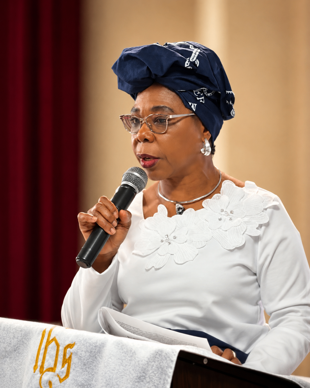 A women's ministry leader giving an address from the front of the church during Mother's Sunday 2026