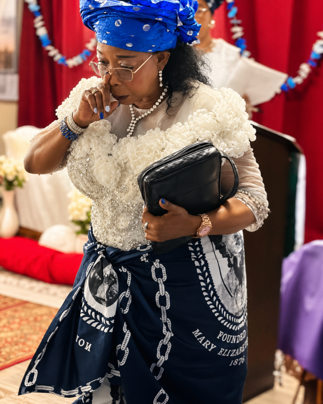 A women's ministry member walking forward to make an offering during Mother's Sunday 2026