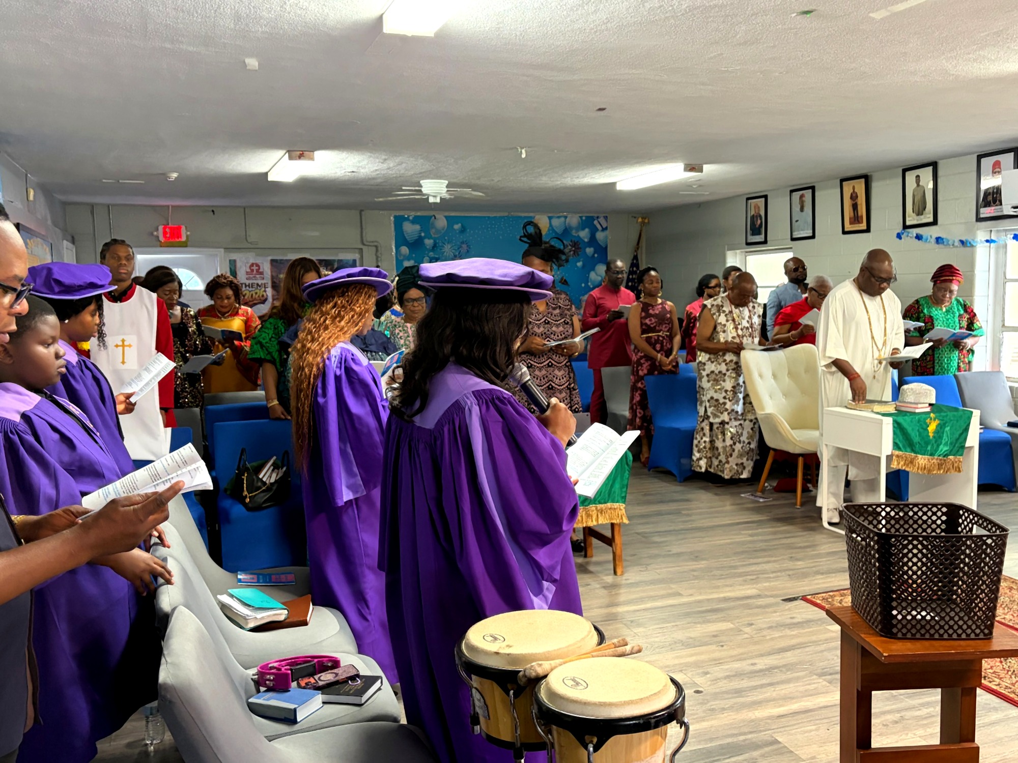Choir leading worship as the congregation stands in praise during the royal thanksgiving visit