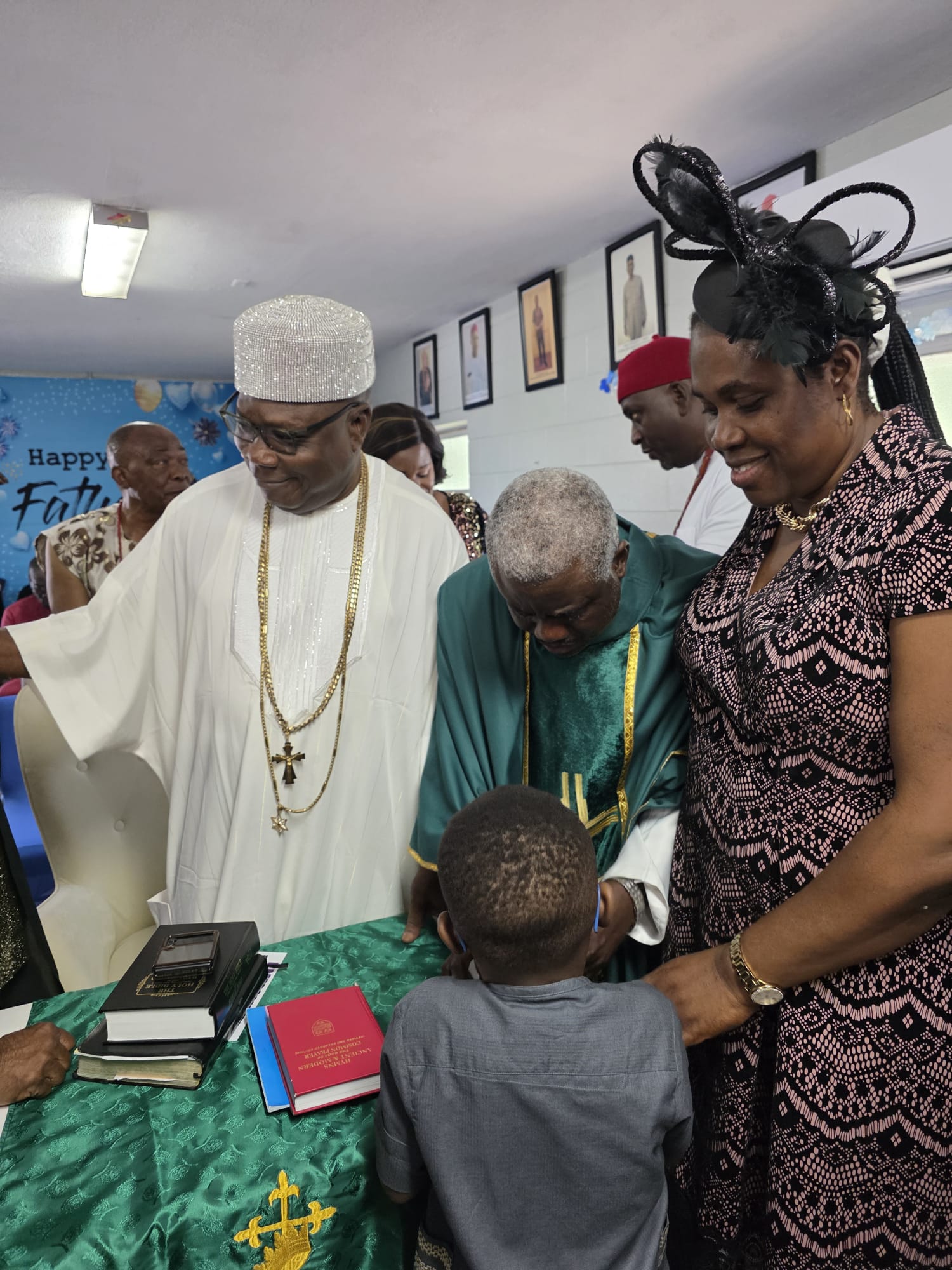 His Royal Majesty and the Rector blessing a young child after the thanksgiving service
