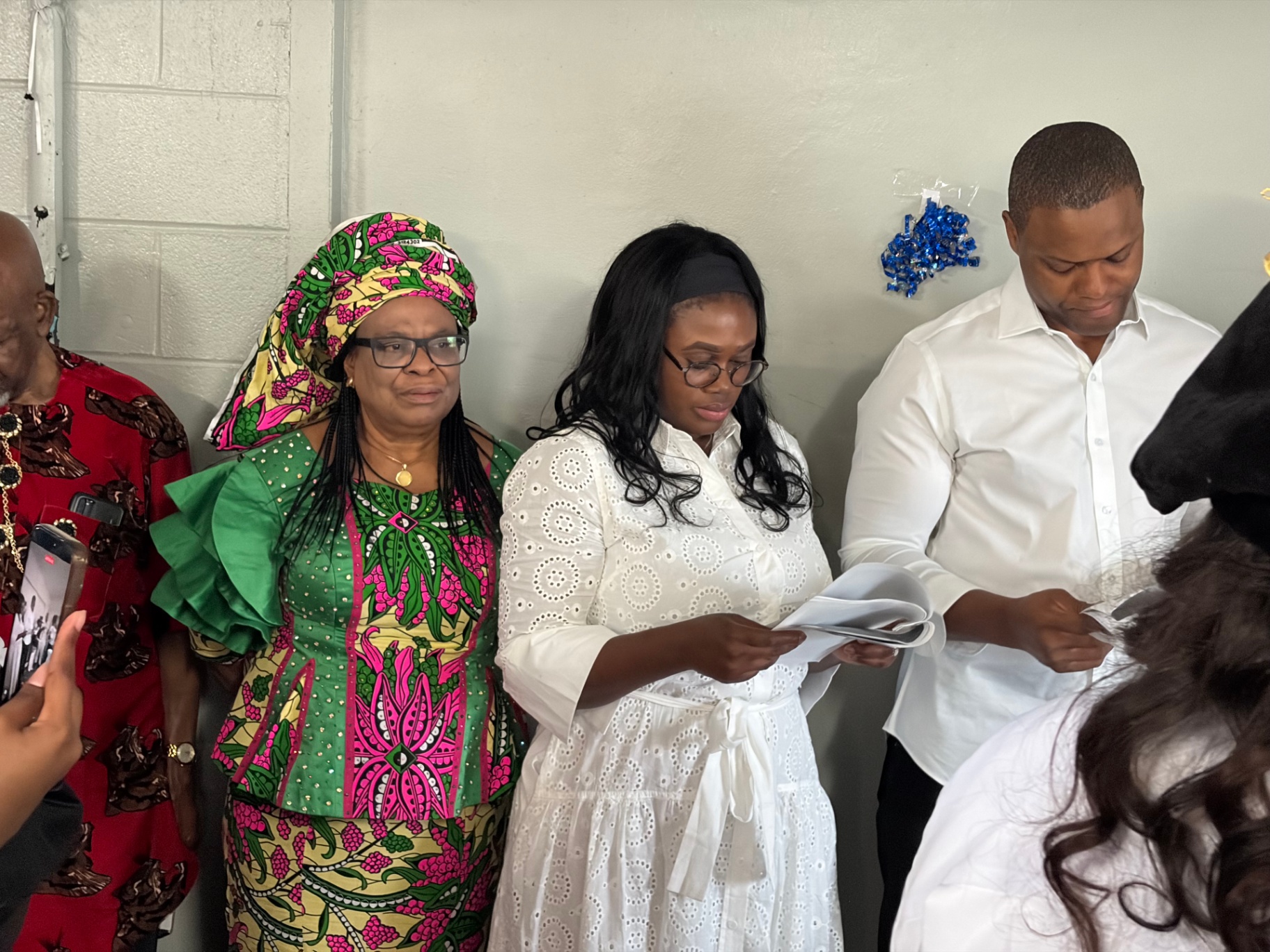 Godparents and family members standing in support