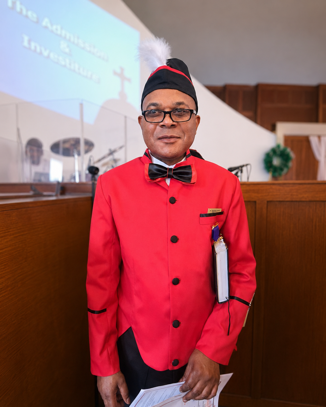 Portrait of a Knights and Dames member in red ceremonial attire inside the church sanctuary