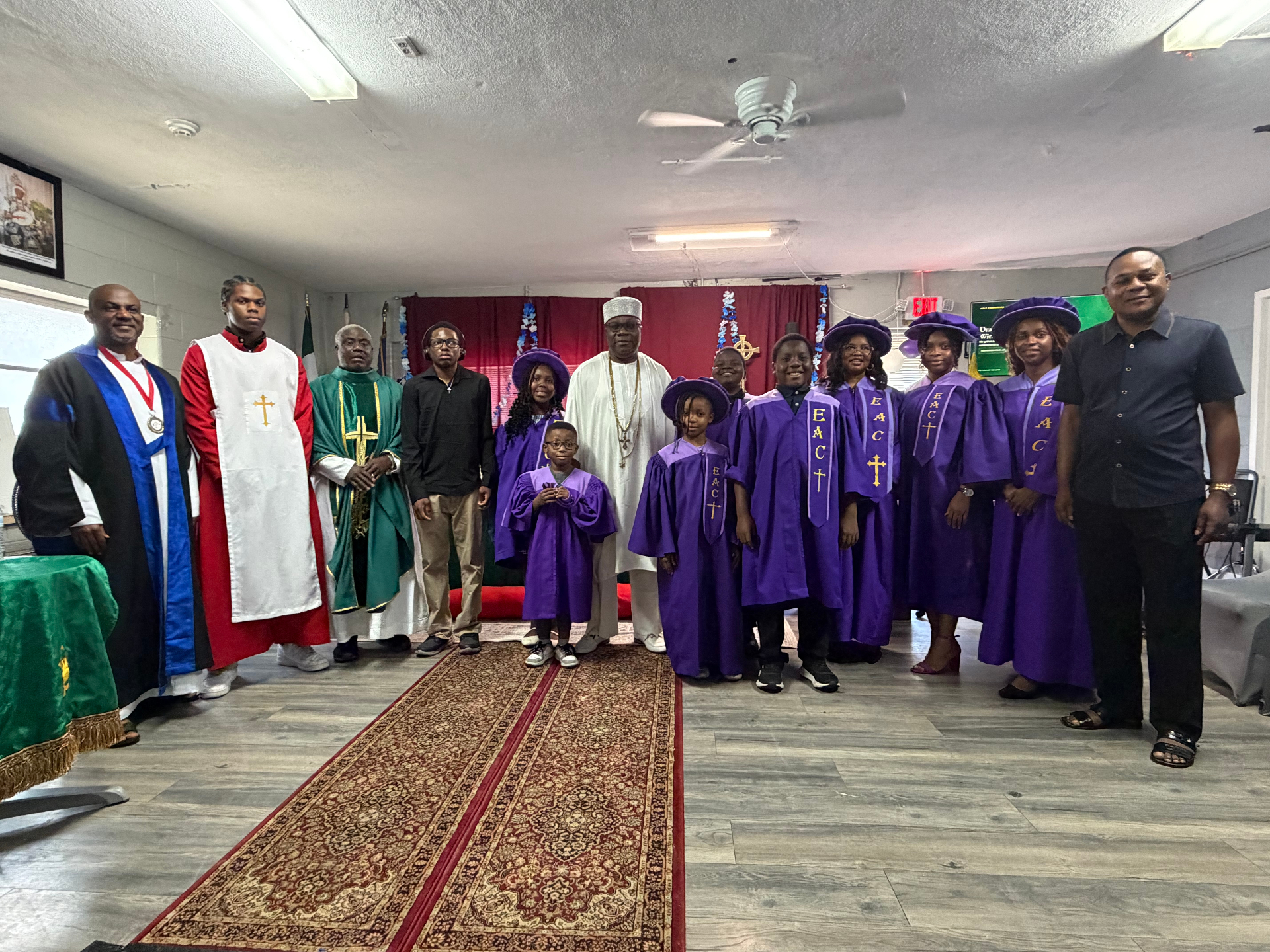 His Royal Majesty Igwe Engr. Sir Augustine C. Emelobe with the Emmanuel Anglican Church choir members in purple robes